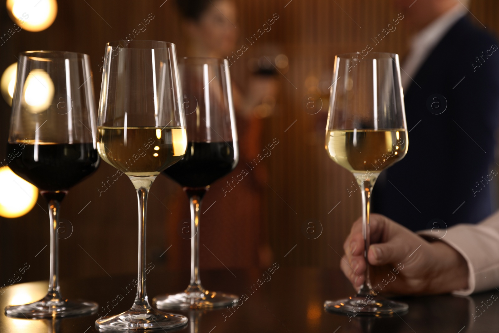 Photo of Woman with glass of wine in restaurant, closeup