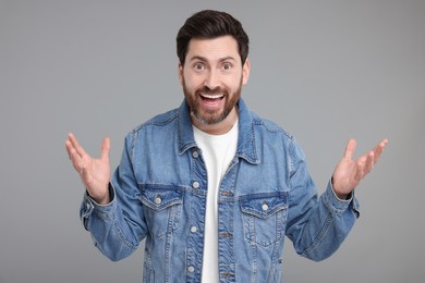 Portrait of surprised man on grey background