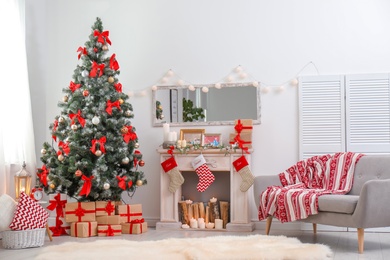 Stylish living room interior with decorated Christmas tree