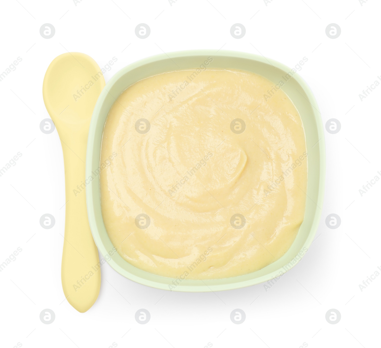 Photo of Tasty baby food in bowl and spoon isolated on white, top view