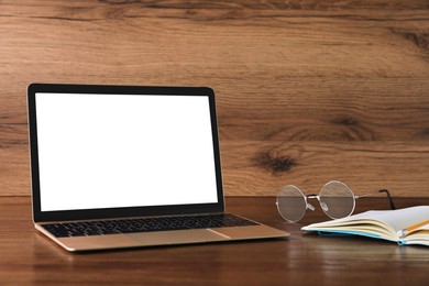 Workplace with modern laptop on wooden table. Mockup for design