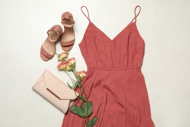 Flat lay composition with stylish coral dress on light stone background