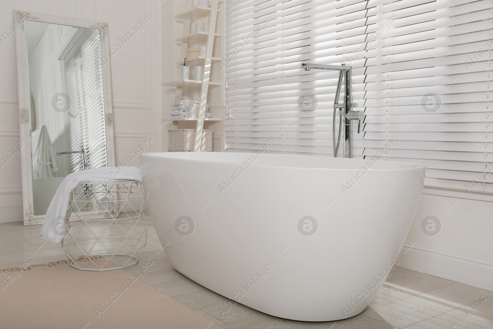 Photo of Minimal bathroom interior with modern white tub