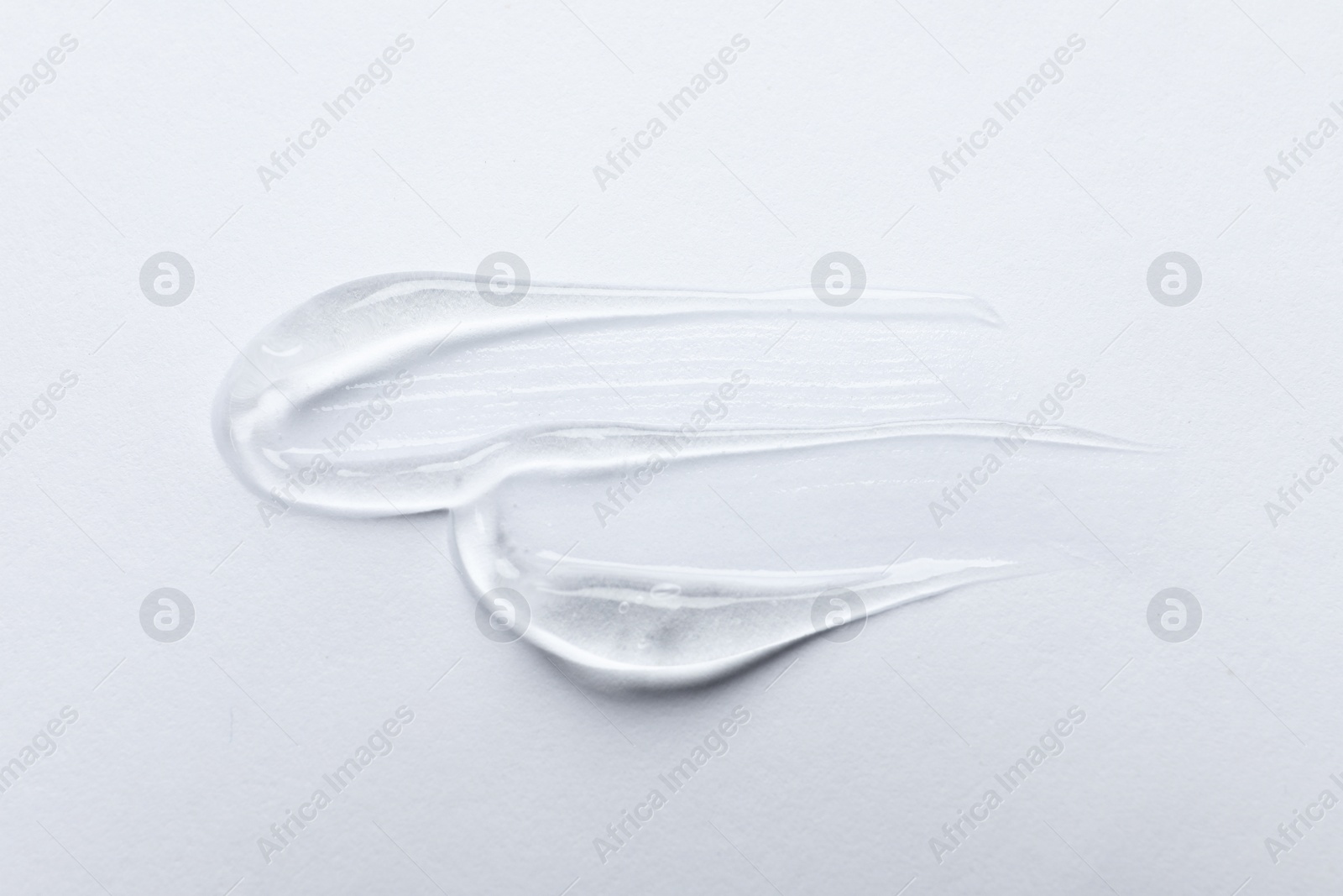 Photo of Swatches of cosmetic gel on white background, top view