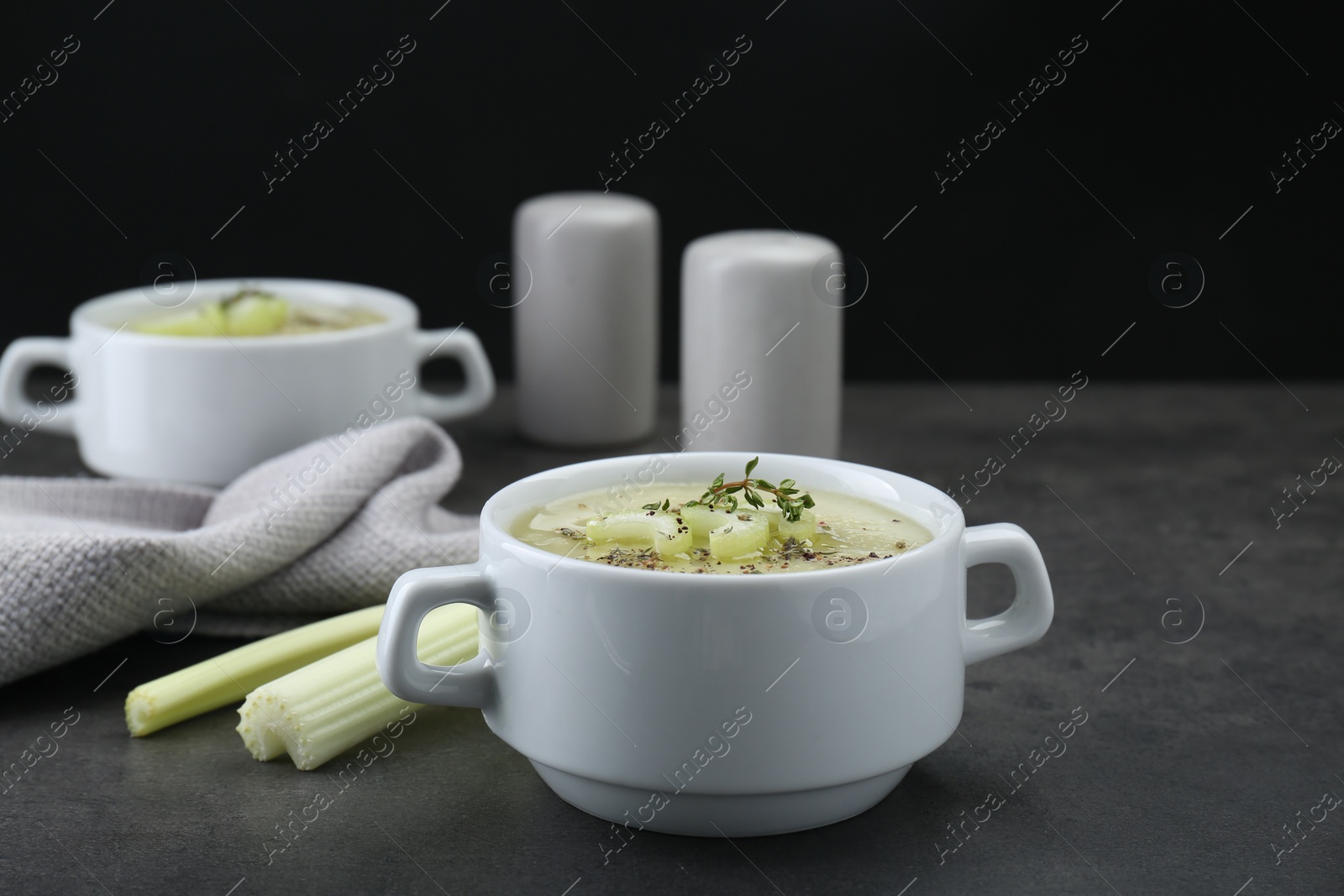 Photo of Bowl of delicious celery soup on gray table