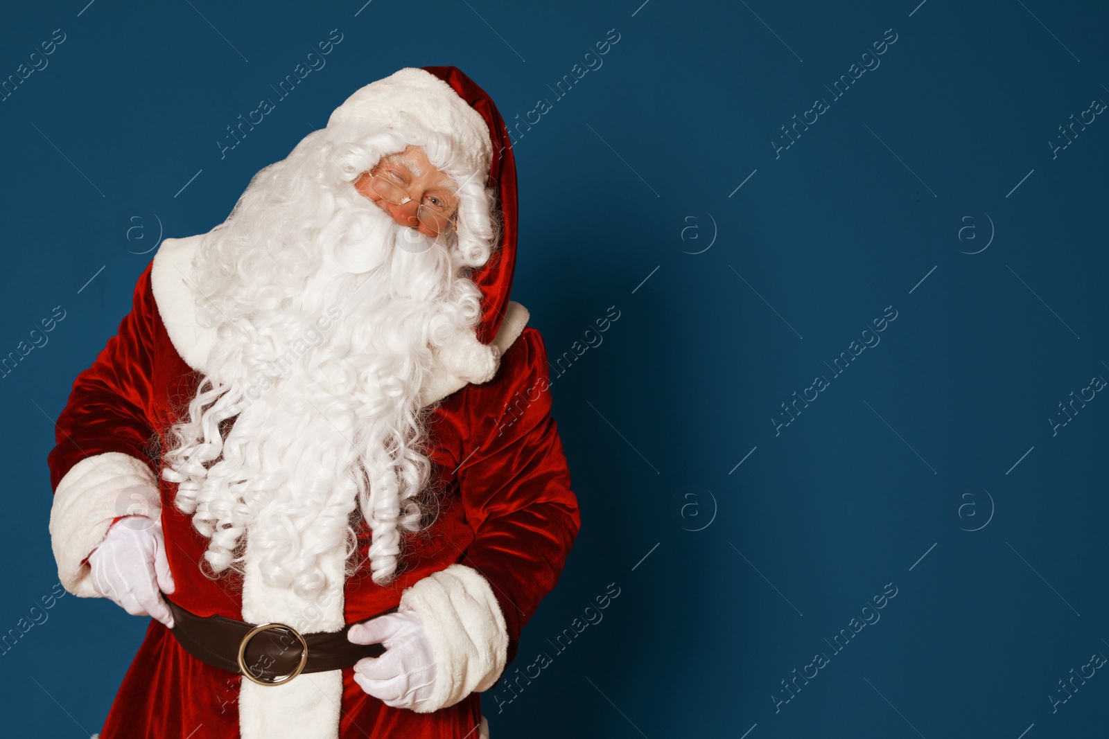 Photo of Authentic Santa Claus on blue background. Space for text