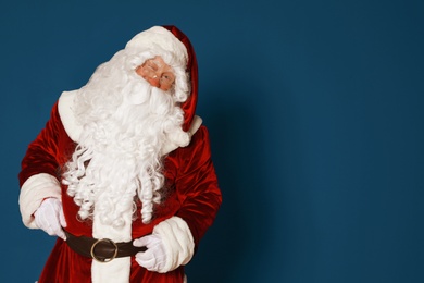 Photo of Authentic Santa Claus on blue background. Space for text