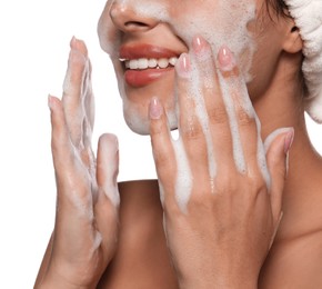 Photo of Beautiful woman applying facial cleansing foam on white background, closeup