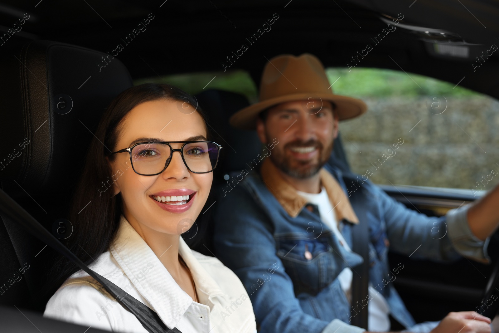 Photo of Happy couple enjoying trip together by car, selective focus