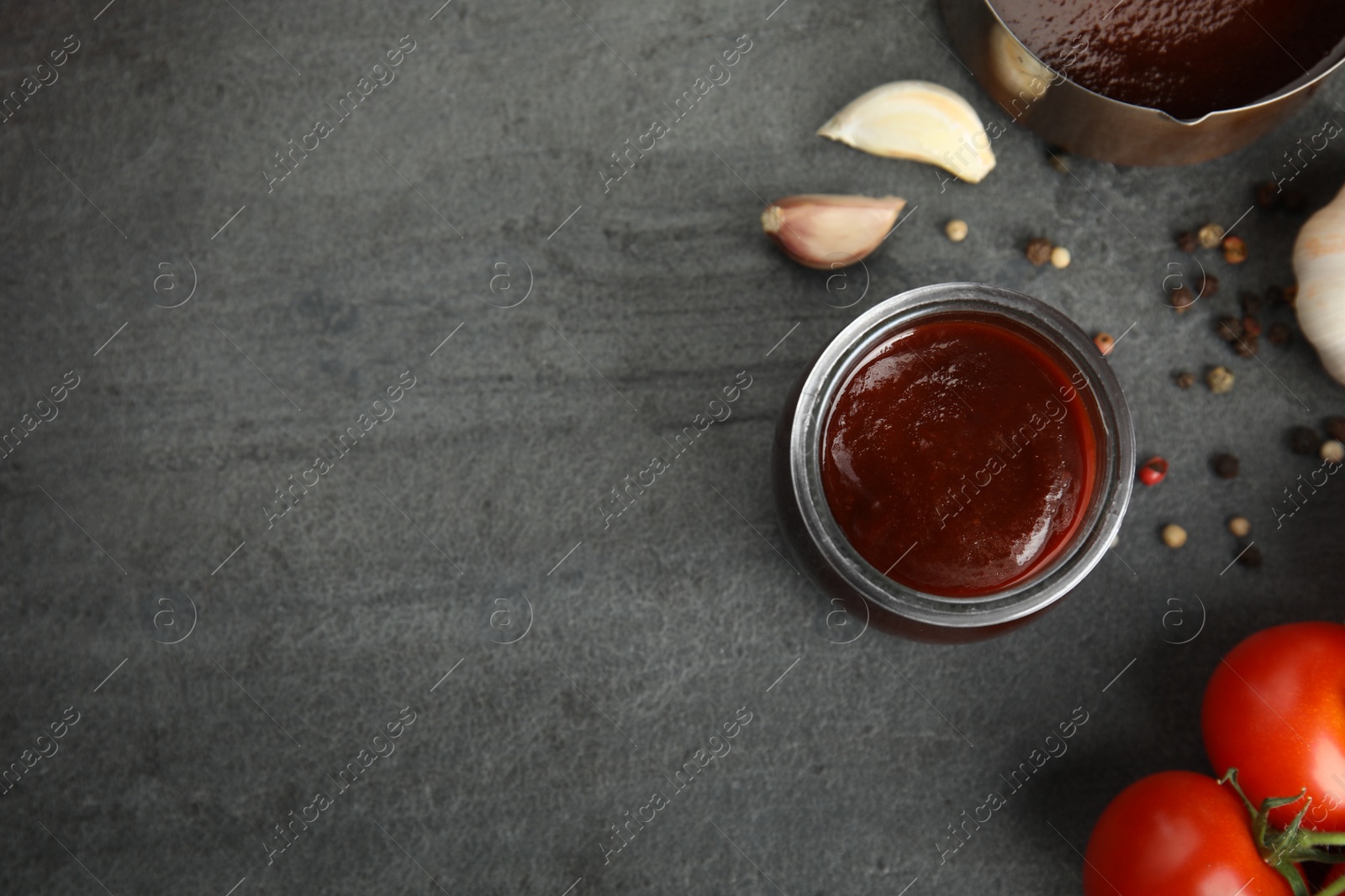 Photo of Flat lay composition with barbecue sauce on grey background. Space for text