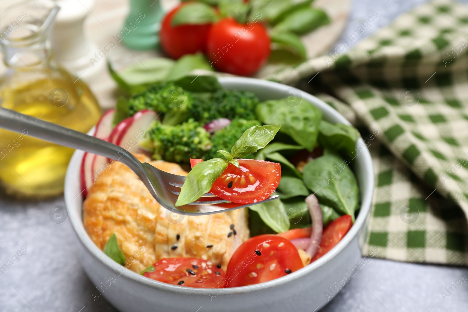 Photo of Healthy meal. Eating tasty vegetables and chicken at table, closeup