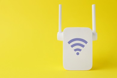 Image of New modern repeater with Wi-Fi symbol on yellow background, space for text