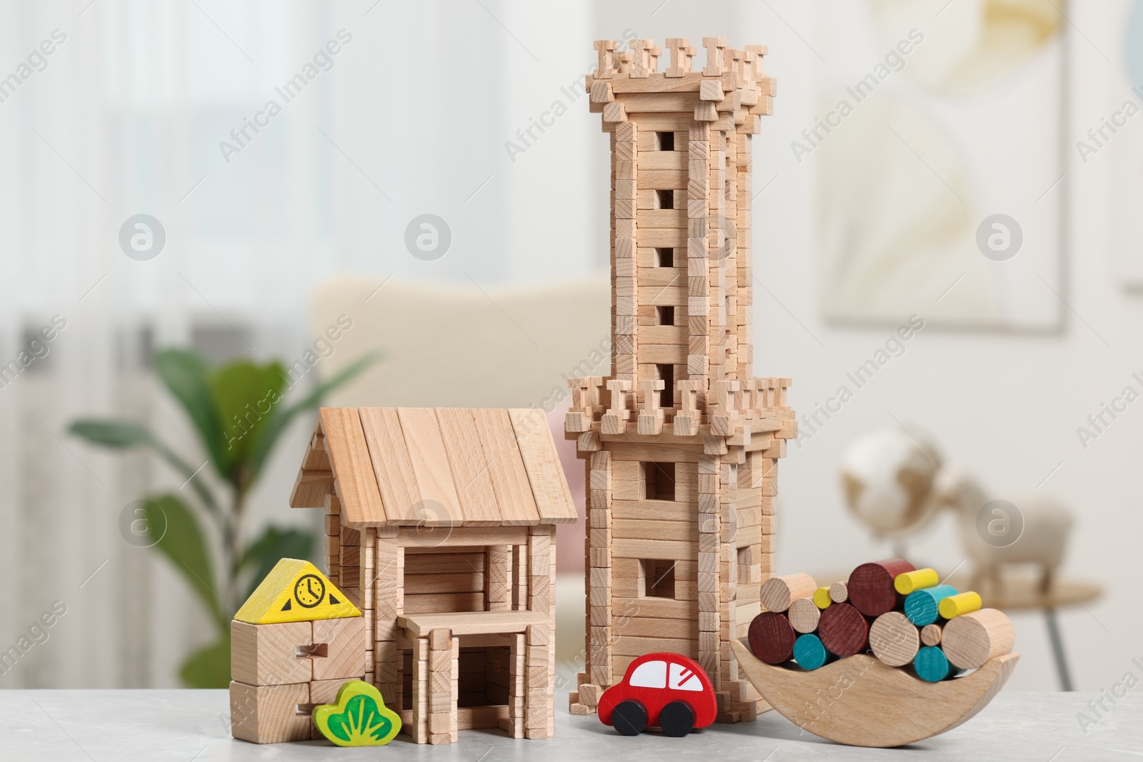 Photo of Set of wooden toys on light grey table indoors. Children's development