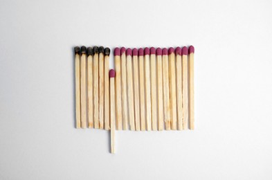 Flat lay composition with burnt and whole matches on white background