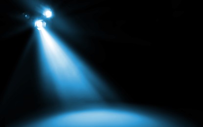 Image of Bright spotlight in darkness. Professional stage equipment