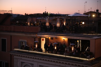 Beautiful view of modern cafe with outdoor roof terrace at sunset