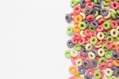 Sweet tasty colorful corn rings on white background, top view