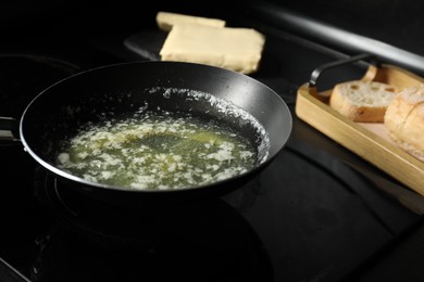 Photo of Melting butter in frying pan on cooktop