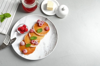 Photo of Flat lay composition with tasty pancakes and berries on table