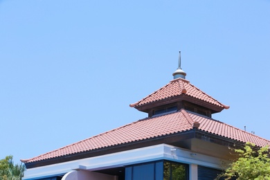 Roof of beautiful building on sky background