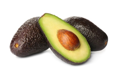 Photo of Cut and whole ripe avocadoes on white background