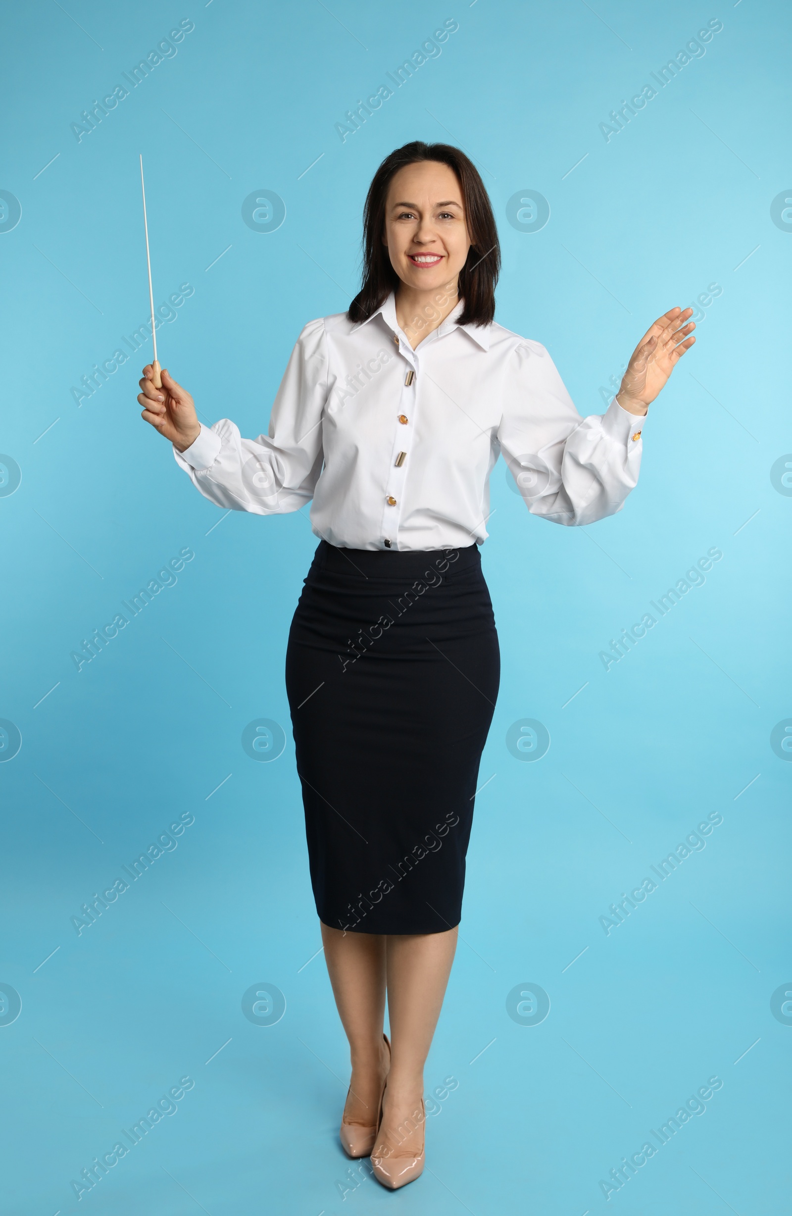 Photo of Music teacher with baton on turquoise background