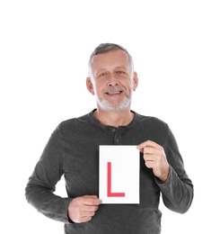 Photo of Happy mature man with L-plate on white background. Getting driving license