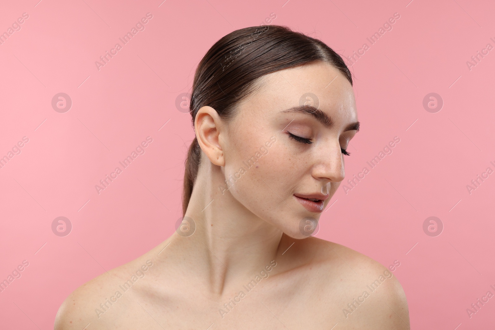 Photo of Portrait of beautiful woman on pink background