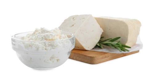 Photo of Different types of delicious tofu cheese with rosemary on white background