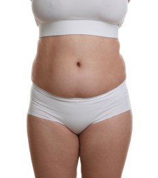 Woman with excessive belly fat on white background, closeup. Overweight problem