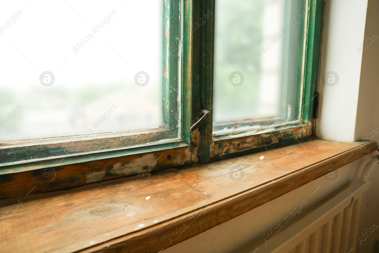 Photo of Old window with wooden sill in room