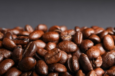 Photo of Roasted coffee beans on grey background, closeup