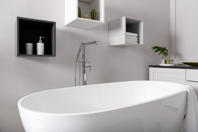 Photo of Stylish bathroom interior with modern white tub