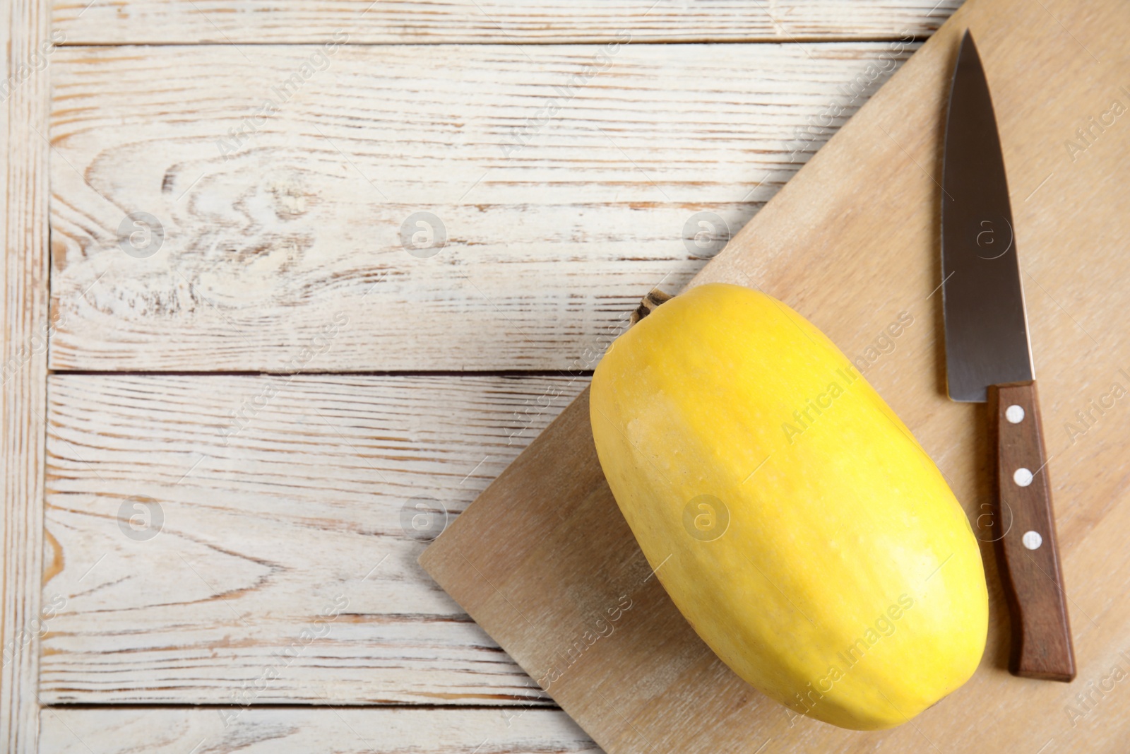 Photo of Flat lay composition with spaghetti squash and knife on wooden background. Space for text