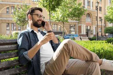 Photo of Handsome man talking on phone in park