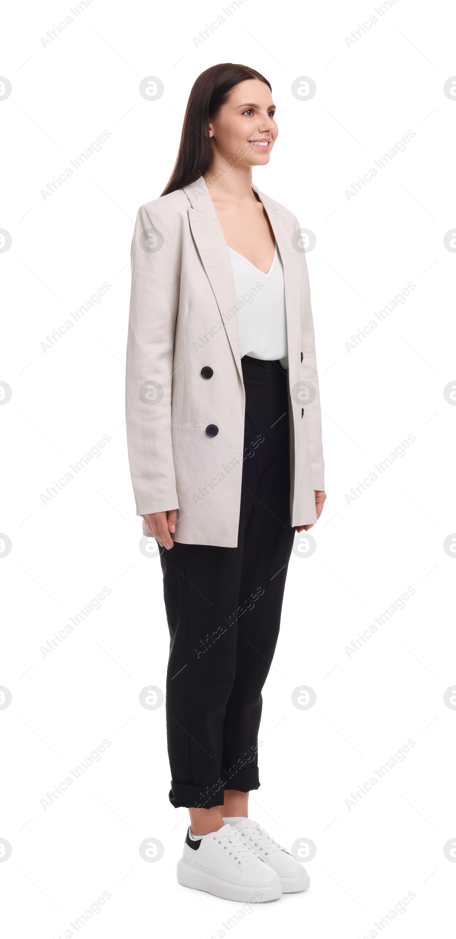 Photo of Young businesswoman in suit standing on white background