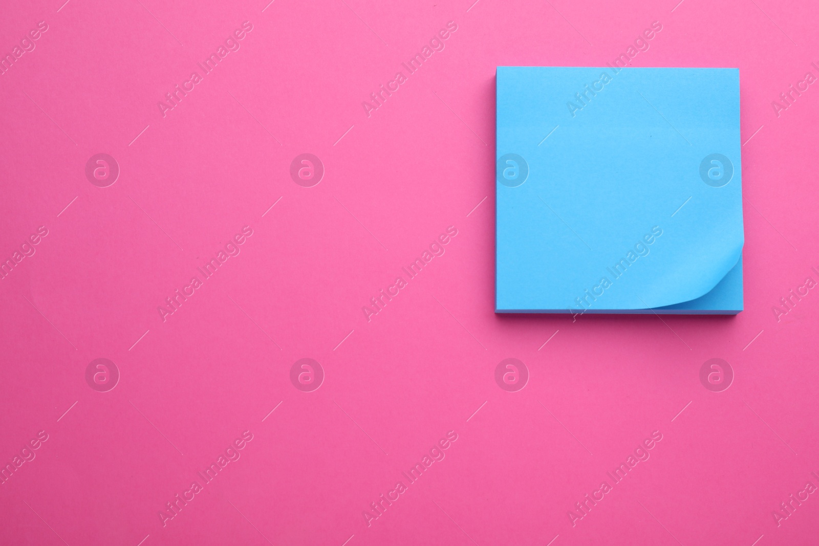 Photo of Paper note on pink background, top view. Space for text