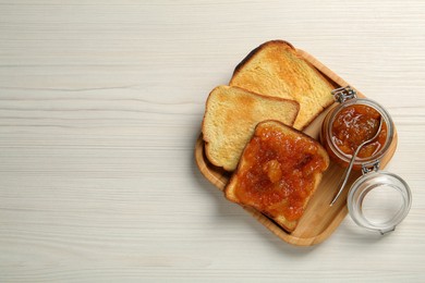 Delicious toasts with jam served on white wooden table, top view. Space for text