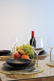 Photo of Bottle of wine and fruits served for dinner indoors, space for text
