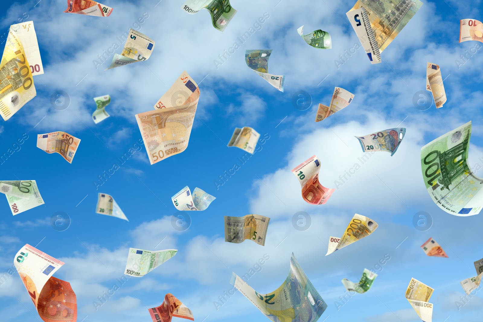 Image of Falling Euro banknotes and blue sky on background. Money rain