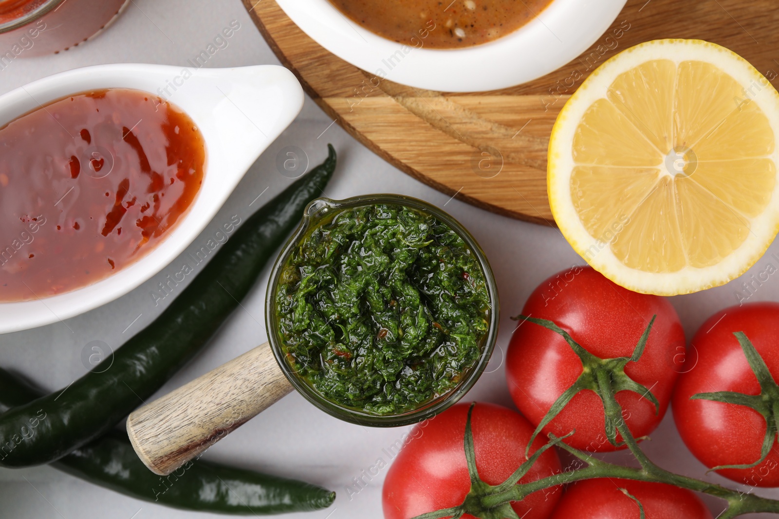 Photo of Different marinades and products on white table, flat lay