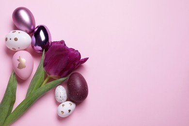 Flat lay composition with tulip and beautifully painted eggs on pink background, space for text. Easter celebration