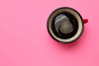 Photo of Fresh coffee in cup on pink background, top view. Space for text