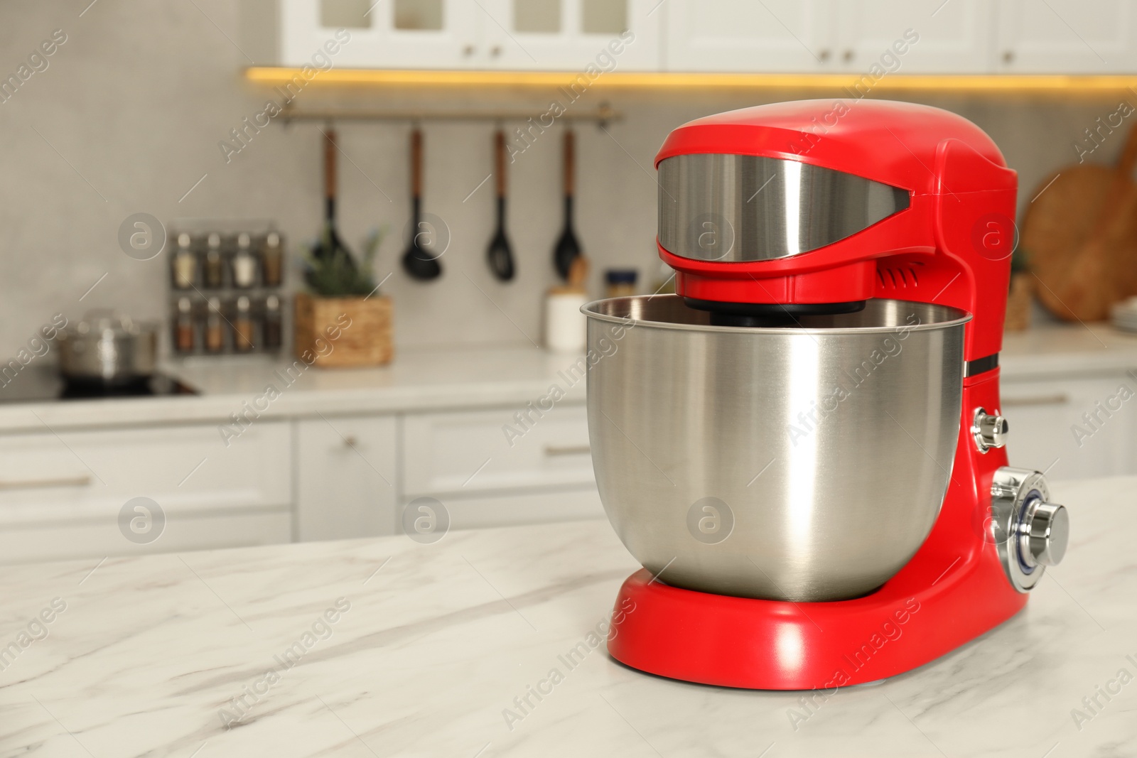 Photo of Modern red stand mixer on white marble table in kitchen, space for text