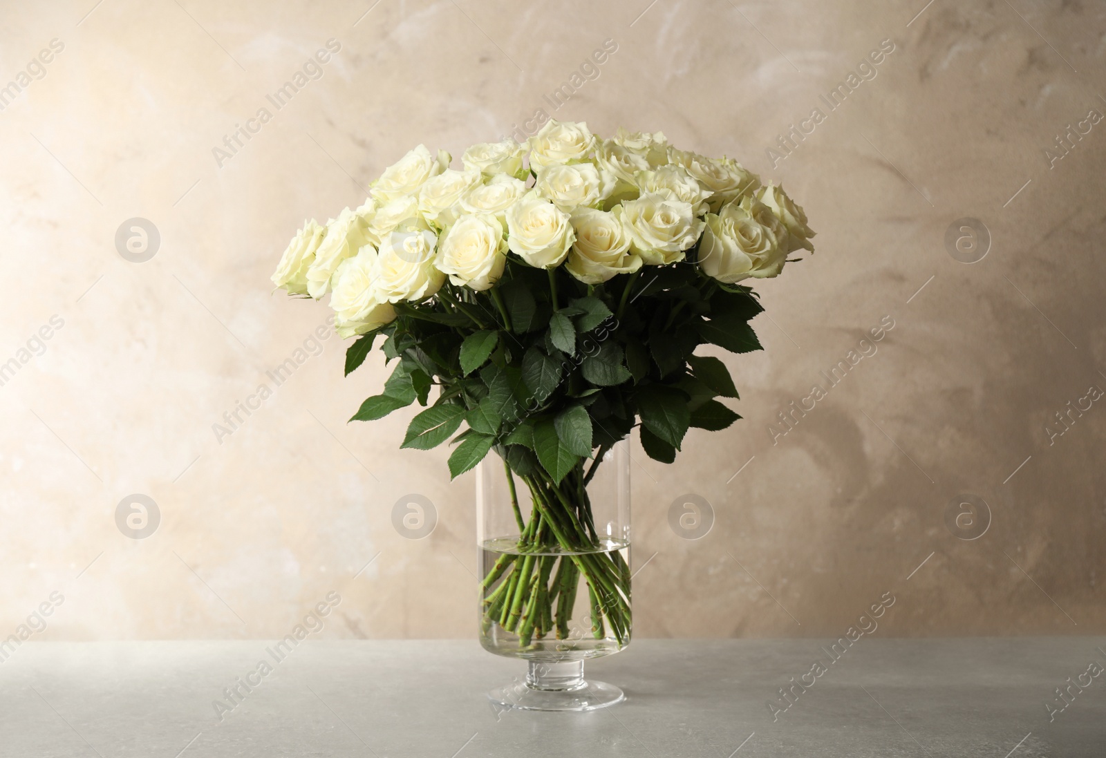 Photo of Luxury bouquet of fresh roses on table