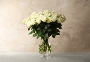 Luxury bouquet of fresh roses on table