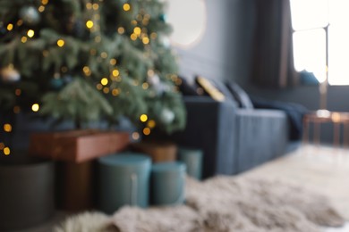 Blurred view of living room interior with Christmas tree and festive decor