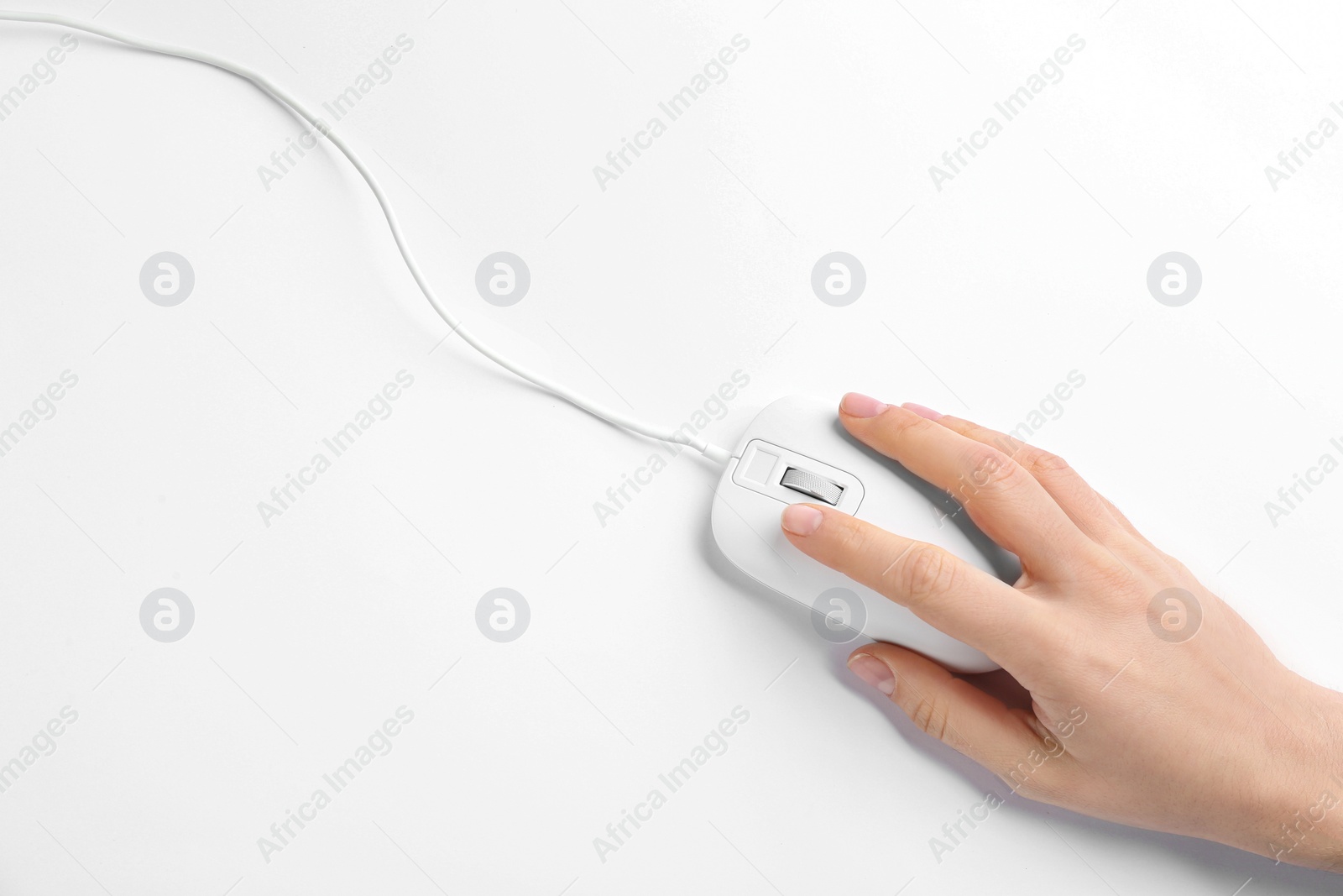 Photo of Woman using modern wired optical mouse on white background, top view