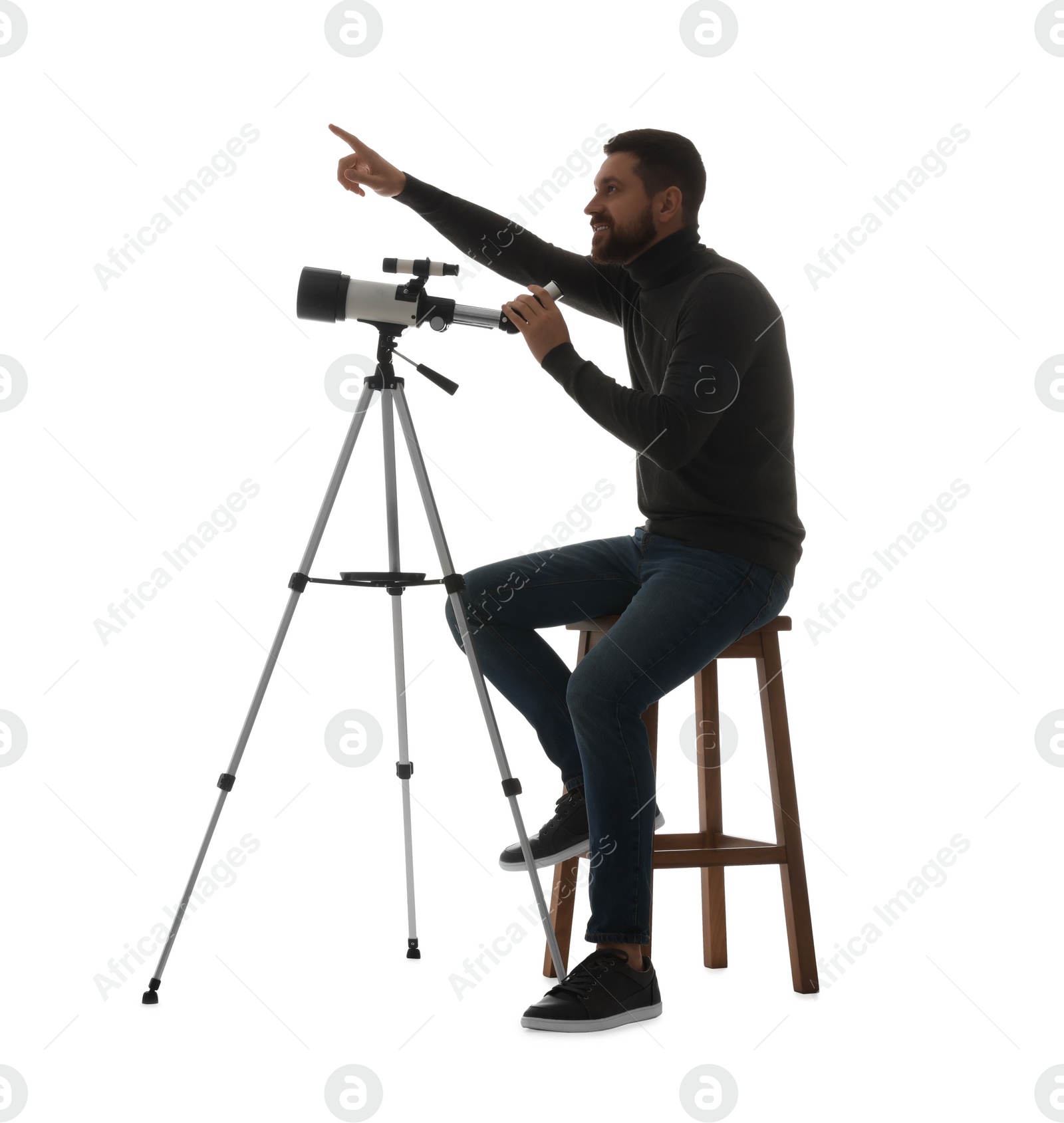 Photo of Happy astronomer with telescope pointing at something on white background