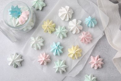 Tasty meringue cookies on light grey table, flat lay